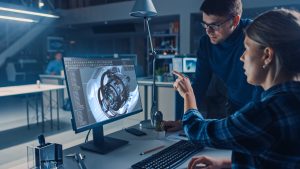 Engineer working on desktop computer Screen showing CAD software